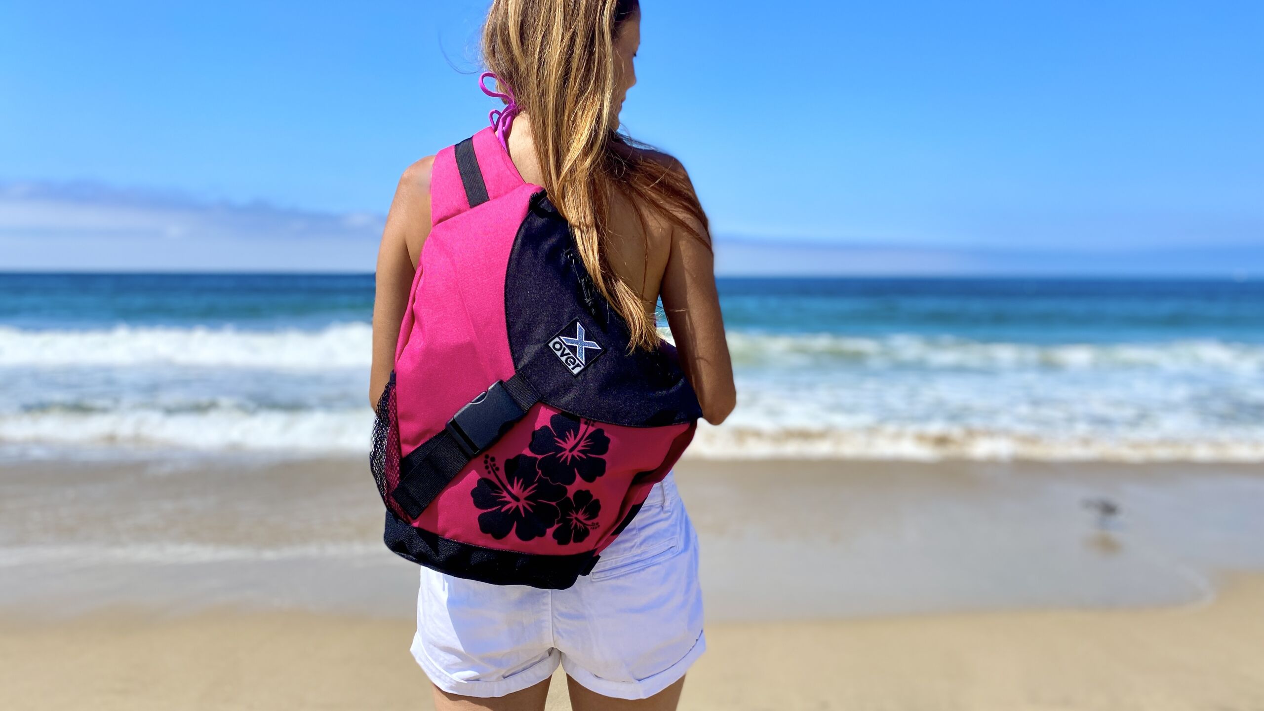 Woman wearing X-over bag standing at the beach