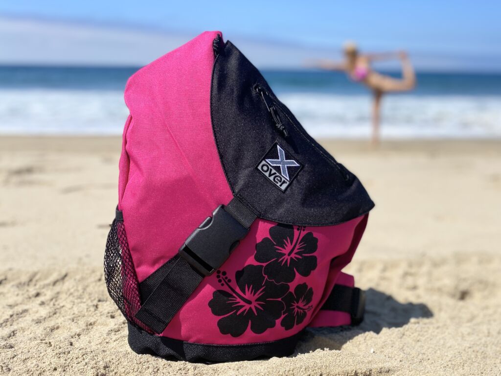 X-over bag in color Hawaiian Spirit with woman doing a yoga pose on the beach
