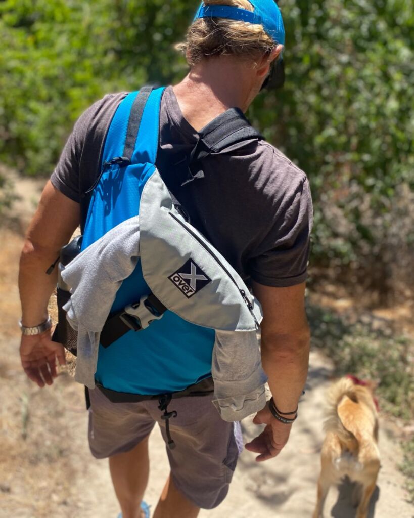 Best outdoor crossbody bag Man hiking and wearing an X-over outdoor crossbody bag