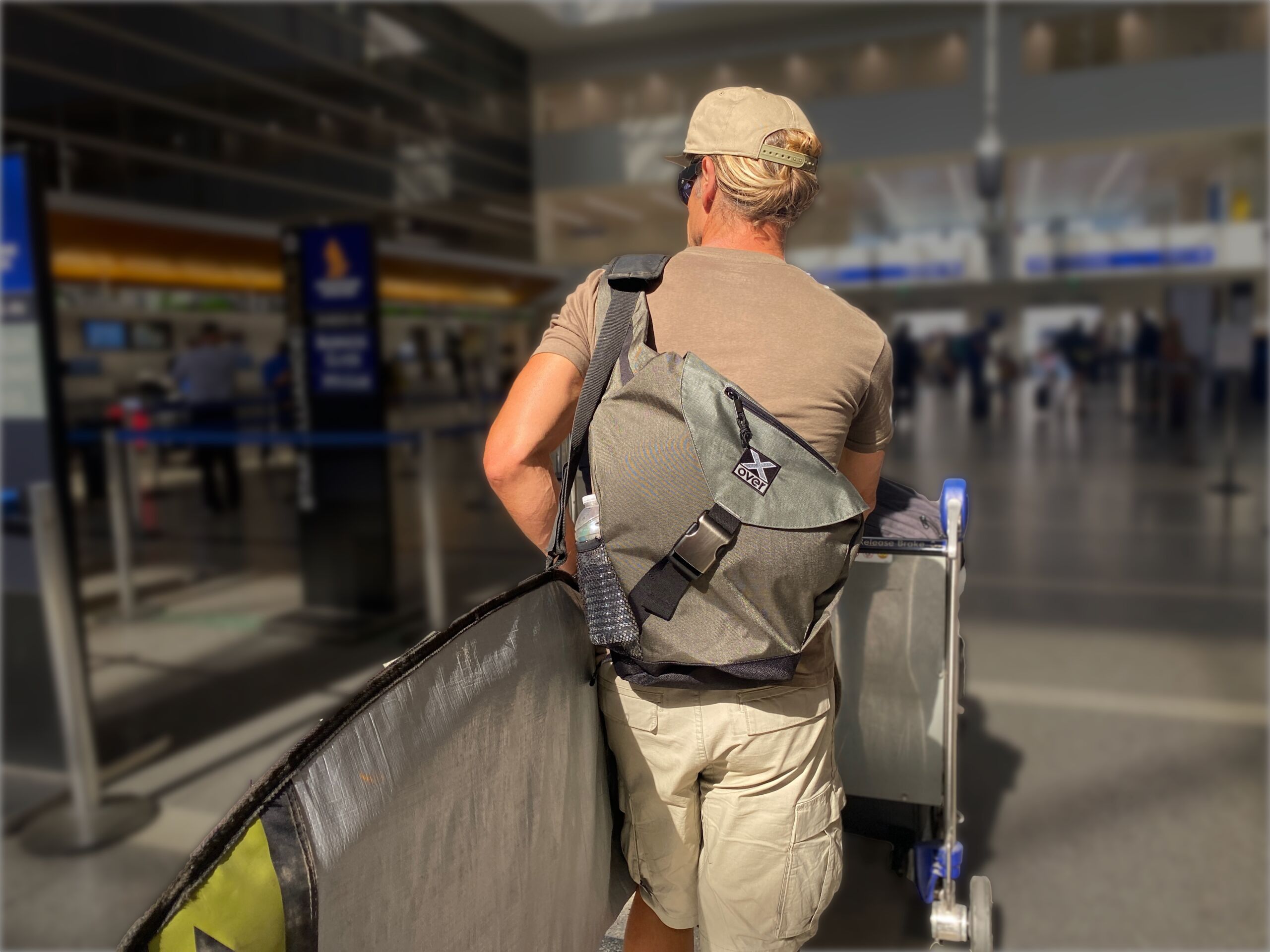 Man wearing X-over bag checking in at the airport