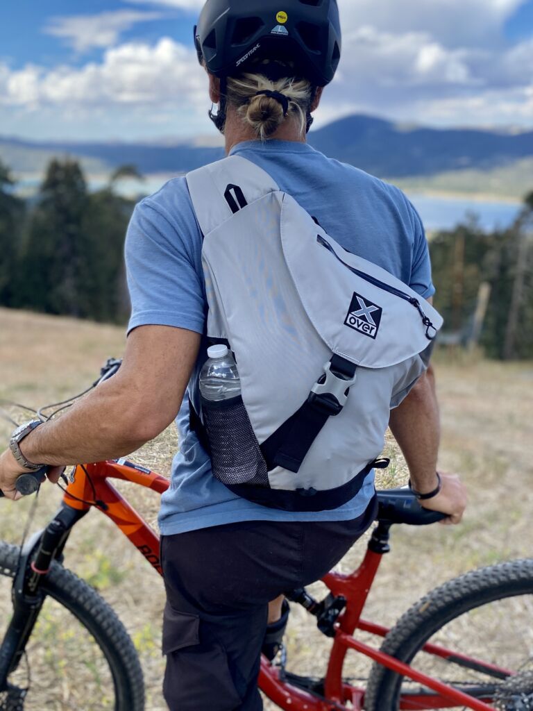 IMG_4066-1 Man wearing X-over bag looks downhill on his MTB