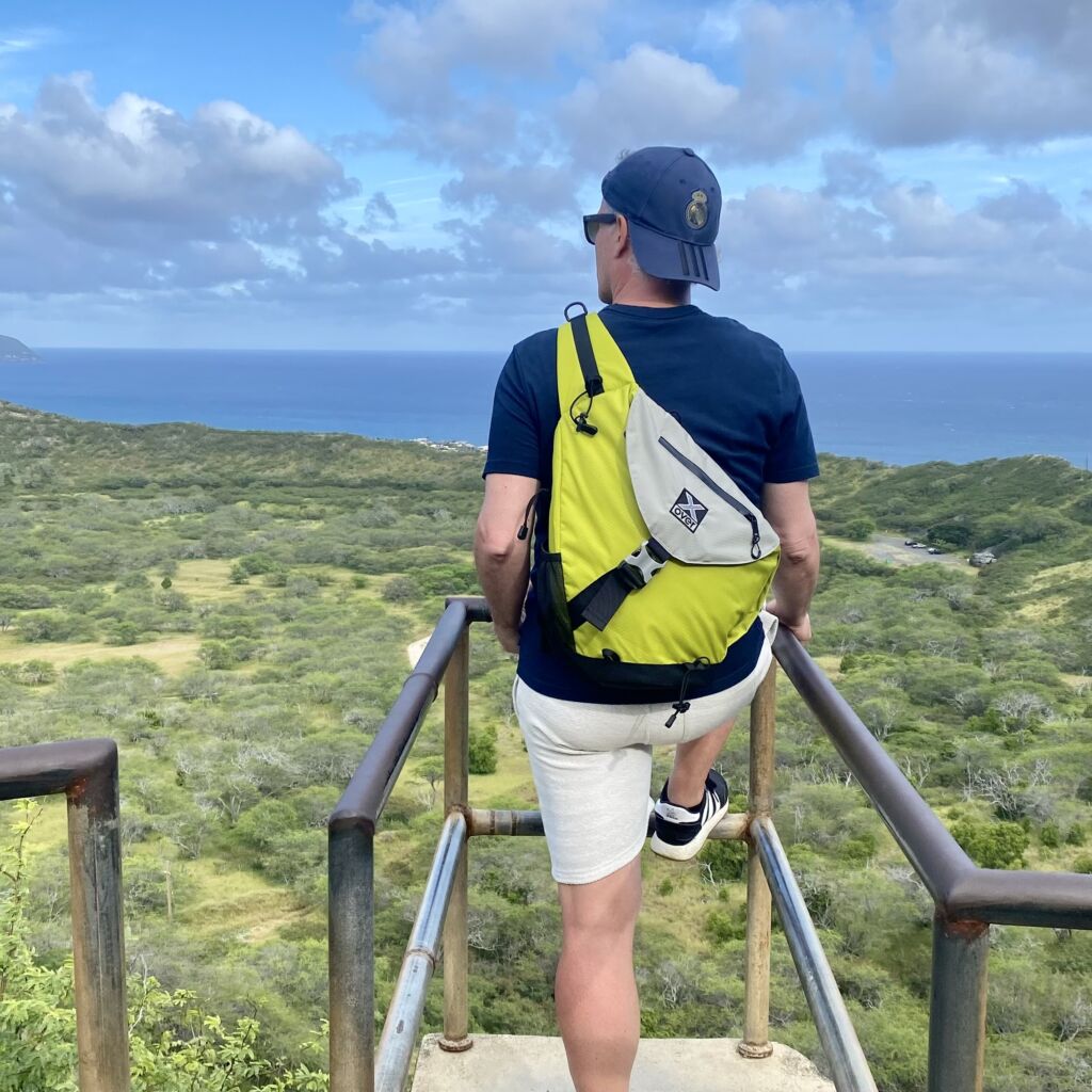 lookout-m man wearing x-over bag looking over landscape